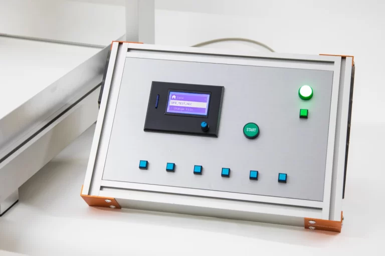 CNC machine control unit with LCD screen and operation buttons.